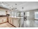Open kitchen with marble island, pendant lighting, white cabinetry, stainless appliances and an open floorplan at 10056 Kings Rd., Myrtle Beach, SC 29572