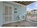 Inviting front porch with seating and charming decor, perfect for enjoying the neighborhood views at 101 W First St. # A2, Ocean Isle Beach, NC 28469
