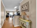 Hallway with wood floors, wall decor, and glimpses of the living room, dining area, and ocean view at 101 W First St. # A2, Ocean Isle Beach, NC 28469