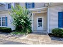 Close-up of the entrance to a townhome with a white front door and unit number at 105 Spring Creek Dr. # C, Myrtle Beach, SC 29588