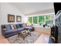 Bright living room with large windows, a gray sectional, and a decorative fireplace with mantle at 1205 Erin Way # 5C, Myrtle Beach, SC 29577