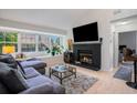 Cozy living room with a decorative fireplace, a large window, and a comfortable gray sectional sofa at 1205 Erin Way # 5C, Myrtle Beach, SC 29577