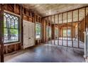 Unfinished living room with exposed beams and plenty of natural light from large windows at 1311 9Th Ave., Conway, SC 29526