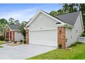 Lovely home with a two car garage, well-manicured lawn, gray siding, brick accents, and a concrete driveway at 183 Glenwood Dr., Conway, SC 29526