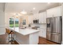 Bright open kitchen with white cabinets, quartz countertops, pendant lighting and stainless appliances at 1844 Wood Stork Dr., Conway, SC 29526
