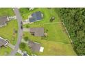 Aerial perspective showcasing the property's layout, large yard, and neighborhood setting at 195 Black Pepper Loop, Little River, SC 29566