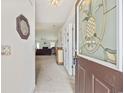 Inviting entryway featuring a decorative glass door, neutral walls, and a view into the living area at 195 Black Pepper Loop, Little River, SC 29566