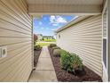 View of the walkway to the home showcasing fresh landscaping and a glimpse of the neighborhood at 195 Black Pepper Loop, Little River, SC 29566