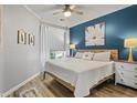 Cozy bedroom featuring wood-look floors, calming blue accent wall and abundant natural light at 1984 Green Fern Ln. # 1984, Myrtle Beach, SC 29579