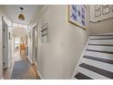 Inviting hallway with stylish decor, leading to a bright and airy living space with elegant staircase at 1984 Green Fern Ln. # 1984, Myrtle Beach, SC 29579