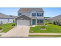 Charming two-story home with blue shutters and a well-manicured lawn at 2106 Ainsley Dr., Little River, SC 29566