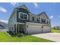 Charming exterior view of a two-story home with a two-car garage and well-maintained landscaping at 215 Vivian St. Nw # 215, Calabash, NC 28467