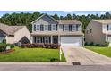Charming two-story home featuring a two-car garage and landscaped front yard at 2709 Eton St., Myrtle Beach, SC 29579
