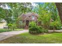 Beautiful brick home with lush landscaping, a circular driveway, and manicured lawn at 469 White Heron Ct. Sw, Sunset Beach, NC 28468