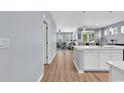 Open-concept view to the Kitchen featuring a large island with an eat-in bar, opening to the Living Room at 520 Cattle Drive Circle, Myrtle Beach, SC 29588