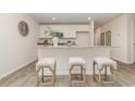 Eat-in kitchen with white cabinets, granite countertops, a breakfast bar with seating, and stainless appliances at 563 Strawberry Field Way, Galivants Ferry, SC 29544