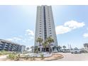 Stunning exterior of a high-rise building with palm trees and convenient parking, showcasing a desirable coastal lifestyle at 5905 South Kings Hwy. # 1414, Myrtle Beach, SC 29575
