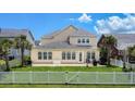 This backyard features a patio and a white picket fence at 6186 Chadderton Circle, Myrtle Beach, SC 29579