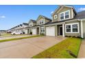 View of modern townhomes, featuring one-car garages and manicured lawns at 623 Harrison Mill St. # 623, Myrtle Beach, SC 29579