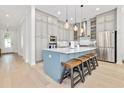 Modern kitchen with stainless steel appliances, stylish cabinets, quartz countertops, and a breakfast bar with seating at 6304 Chadderton Circle, Myrtle Beach, SC 29579