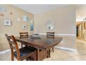Cozy dining area with a wooden table, seating for four, and coastal-themed decor at 704 S Ocean Blvd. # 304A, Myrtle Beach, SC 29577