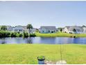 Beautiful backyard overlooking a tranquil pond, surrounded by well-maintained lawns and other homes at 708 Shenanigan Loop, Murrells Inlet, SC 29576