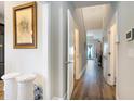 Bright hallway with hardwood floors leading to various rooms at 724 Hobonny Loop, Longs, SC 29568