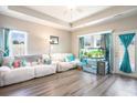 Cozy living room with ample natural light, a ceiling fan, and stylish decor at 724 Hobonny Loop, Longs, SC 29568
