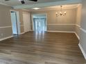 Spacious living room with light-colored walls, white trim, hardwood floors, and ample natural light at 876 S Clay Field Rd, Johnsonville, SC 29555