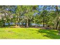 Lush backyard with mature trees and partial view of the waterfront at 1032 Chelsey Circle, Conway, SC 29526