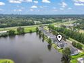 Overhead view of homes and a lake with surrounding trees under a partly cloudy sky at 1048 Meadowoods Dr., Murrells Inlet, SC 29576