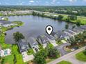 Aerial view of lakeside homes with lush trees and landscaping, as well as a view of the highway in the distance at 1048 Meadowoods Dr., Murrells Inlet, SC 29576