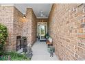 Covered brick entryway with a ceiling fan, bench seating, and a view of the front door at 107 Fox Den Dr., Murrells Inlet, SC 29576