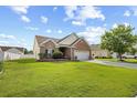 Well-maintained brick house with lush green lawn, mature trees, and attached two car garage at 107 Fox Den Dr., Murrells Inlet, SC 29576