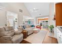 Open-concept living room featuring a vaulted ceiling, hardwood floors, and a spacious seating area at 107 Fox Den Dr., Murrells Inlet, SC 29576