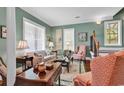 Relaxing living room features hardwood floors, lots of light, neutral paint, and comfortable seating at 128 Knotty Pine Way, Murrells Inlet, SC 29576