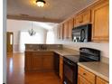 Well-equipped kitchen with wooden cabinets and modern black appliances at 140 Blue Pride Dr., Loris, SC 29569