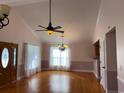 Spacious living room with hardwood floors, lots of windows and vaulted ceilings at 140 Blue Pride Dr., Loris, SC 29569