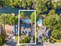 Aerial view showcasing a home with a backyard pool and direct waterway access at 174 Edward Ave., Murrells Inlet, SC 29576