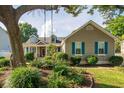 Inviting home featuring beautiful landscaping, a cozy porch, and blue window shutters at 174 Edward Ave., Murrells Inlet, SC 29576
