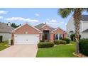 Charming brick home with a well-manicured lawn and an attached two-car garage at 2210 Haystack Way, Myrtle Beach, SC 29579