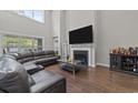 Living room features fireplace, hard wood floors, and a cozy sectional couch at 2212 Leeboard Ct., Myrtle Beach, SC 29579