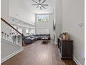 Open concept living room with tall ceilings, hard wood floors, and a large window at 2212 Leeboard Ct., Myrtle Beach, SC 29579