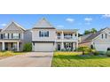 Inviting two-story home features a covered front porch and attached garage, set in a well-maintained neighborhood at 226 Calhoun Falls Dr., Myrtle Beach, SC 29579