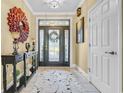Bright foyer featuring a decorative front door, tile flooring, console table and stylish rug at 2369 Clandon Dr., Myrtle Beach, SC 29579