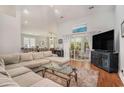 Spacious living room with a large sectional sofa, wood floors, and sliding glass doors to the patio at 2510 Oriole Dr., Murrells Inlet, SC 29576