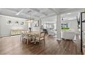 Elegant dining room with coffered ceilings, pendant lighting, and open access to the kitchen and living areas at 264 Switchgrass Loop, Little River, SC 29566