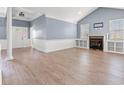 Bright living room with fireplace, built-in shelves, neutral walls, and luxury vinyl plank flooring at 307 Russ Rd., Loris, SC 29569