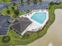 Community pool and pool house with ample deck chairs, and parking nearby at 314 Black Oak Ln. # 102, Murrells Inlet, SC 29576