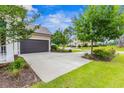 Large driveway with ample parking and beautiful landscaping in a residential neighborhood at 496 Starlit Way, Myrtle Beach, SC 29579